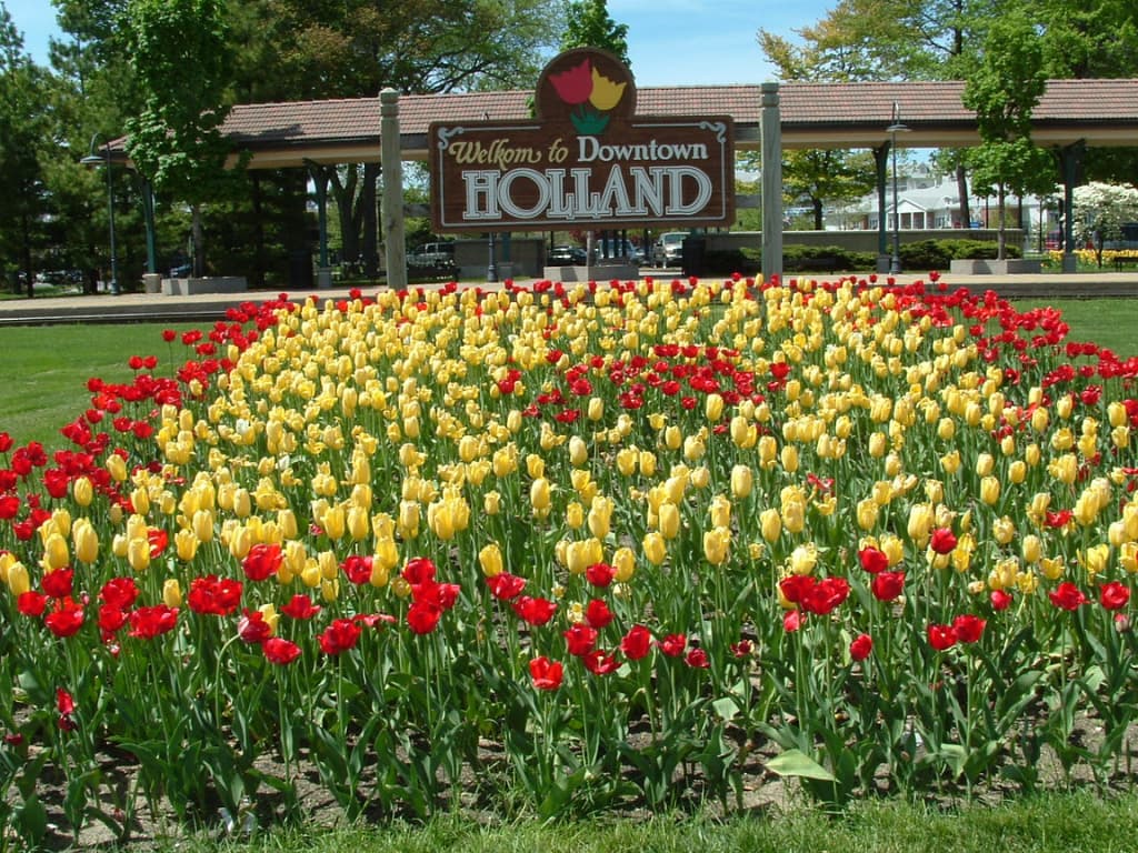 Sign welcoming visitors to Holland, Michigan with tulips