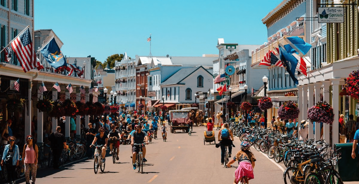Mackinac Island Main Street with people shopping, riding bikes and walking