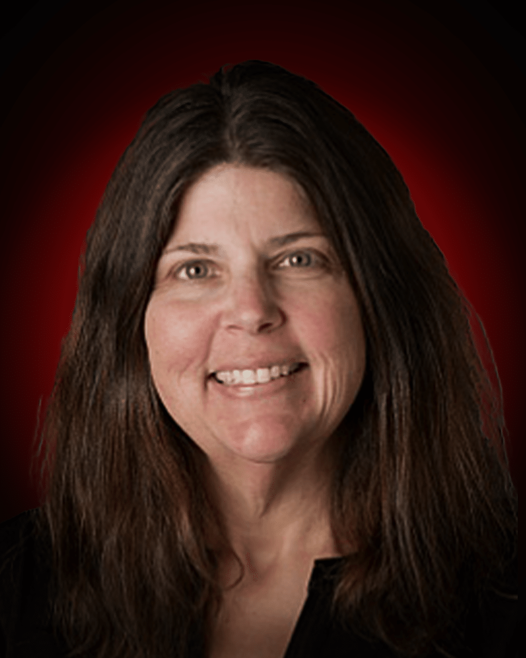 Christina Campbell – Customer Service for Making Memories Tours, woman smiling against a red backdrog